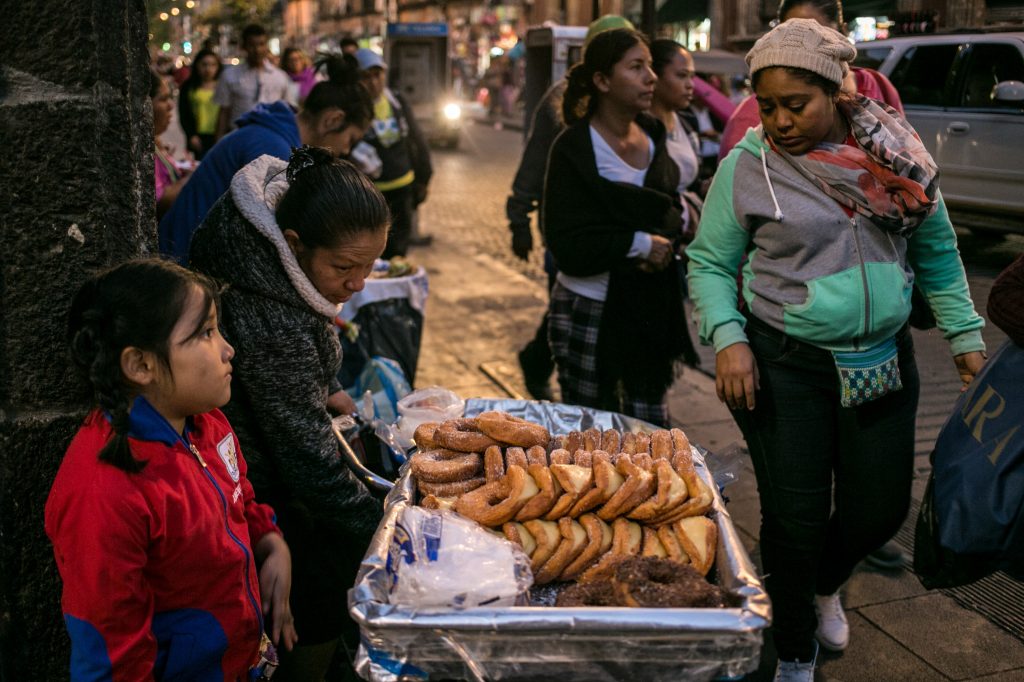 A family sells pastries in Mexico City. As Mexicans’ wages have risen, their average daily intake of calories has soared. A variety of fried snacks and soft drinks are for sale in Mexico City's Centro Historico neighborhood. (Meghan Dhaliwal/for NPR)