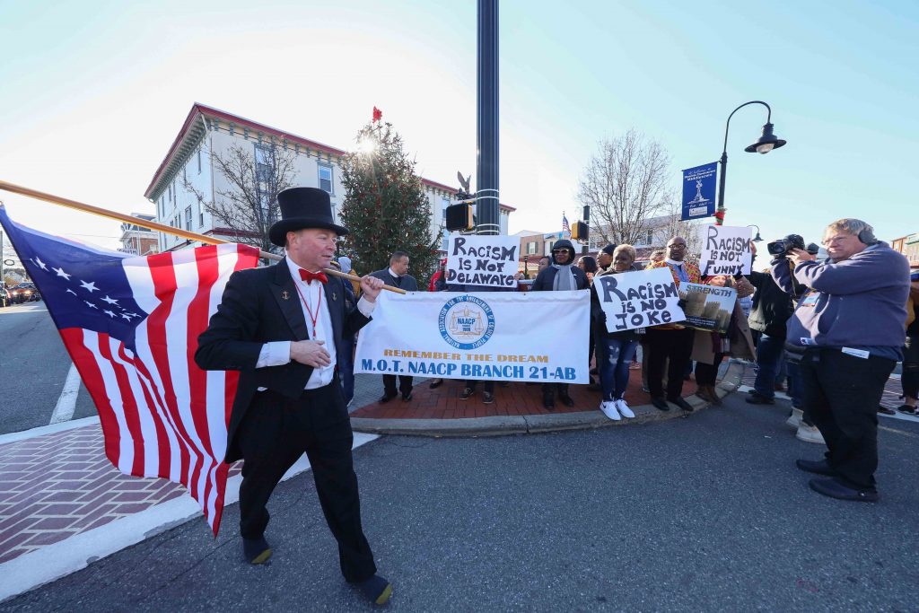 NEWS 2020 – JAN 01 – Many attended the 49th unofficial annual Hummers Parade Jack Schreppler, Hummers Parade 'Grand Marshal for life' walks past protesters after greeting them during the Hummers Parade. (Saquan Stimpson for WHYY)