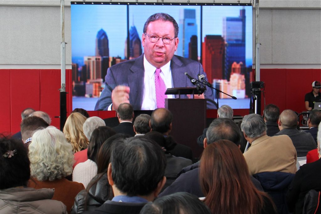 2019 11 08-david l cohen-philadelphia crane chinatown Comcast's David L. Cohen delivers a video address to the crowd at the grand opening of the Crane Chinatown community center on Nov. 8, 2019. Comcast was a major donor to the project. (Emma Lee/WHYY)