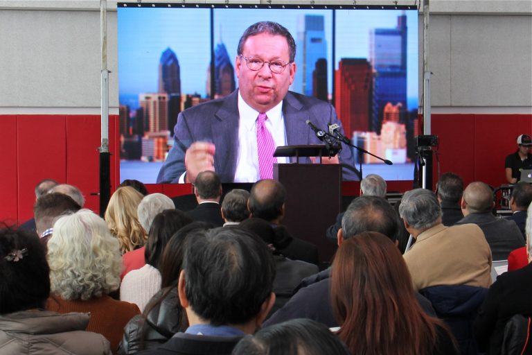 Comcast's David L. Cohen delivers a video address to the crowd at the grand opening of the Crane Chinatown community center on Nov. 8, 2019. Comcast was a major donor to the project. (Emma Lee/WHYY)