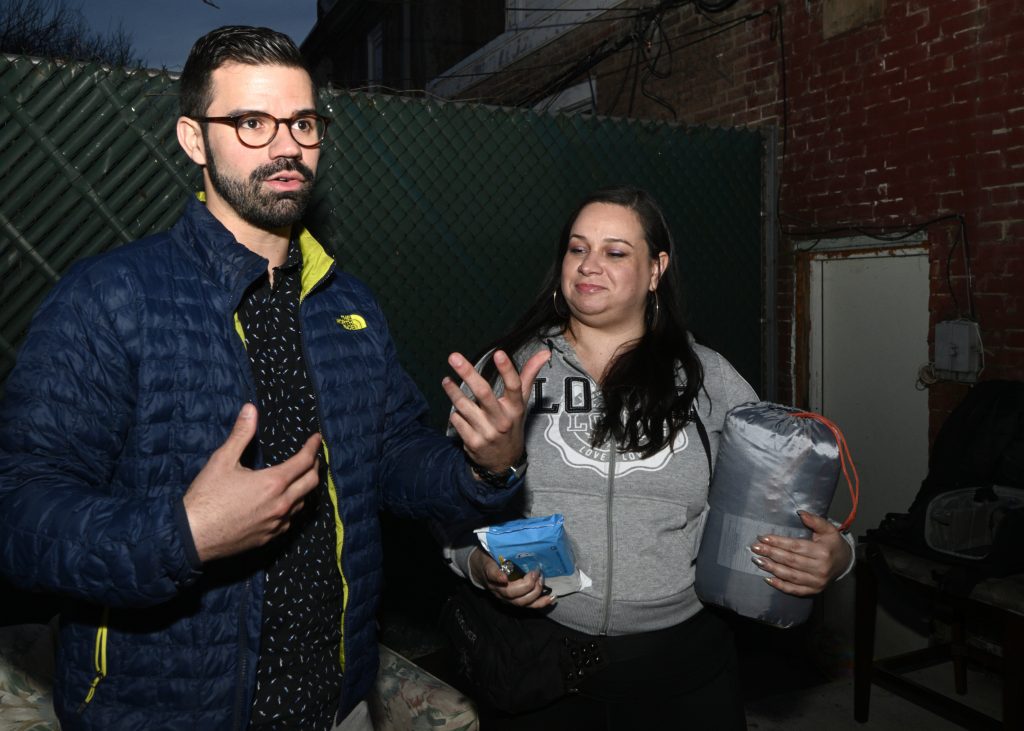 Philly Boricuas Plans to Donate Disaster Relief to PR Activist and community organizer Adrian Rivera-Reyes and Vanessa Maria Graber pack emergency items to be donated as a disaster relief package, during a meeting of Philly Boricuas, on Saturday, in North Philadelphia. (Bastiaan Slabbers for WHYY)