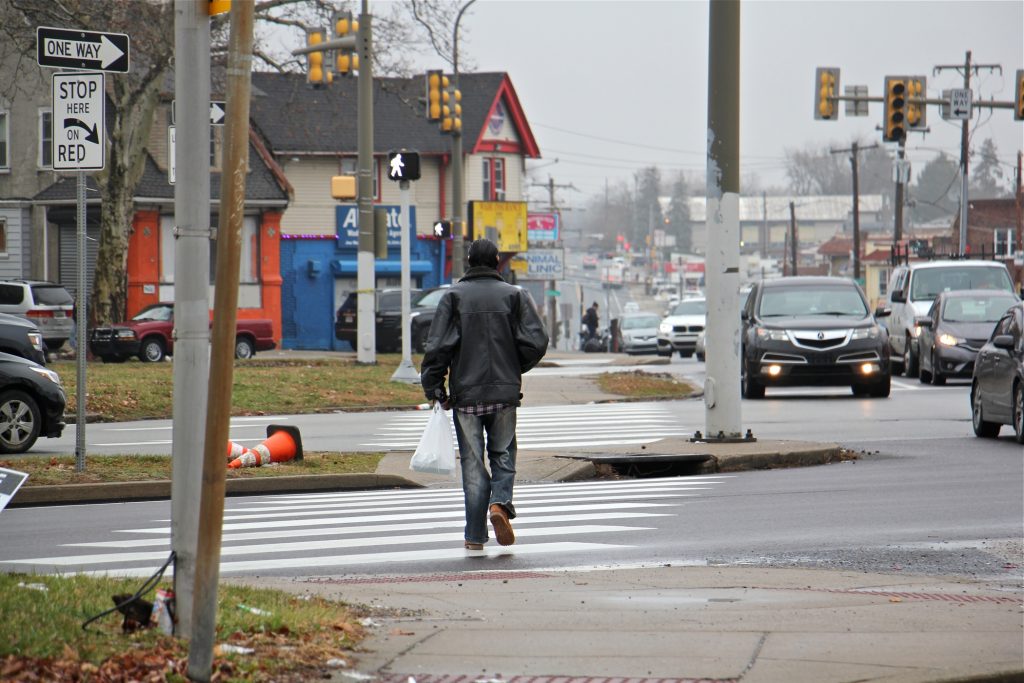 A pedestrian crosses Roosevelt Boulevard at Rising Sun Avenue.