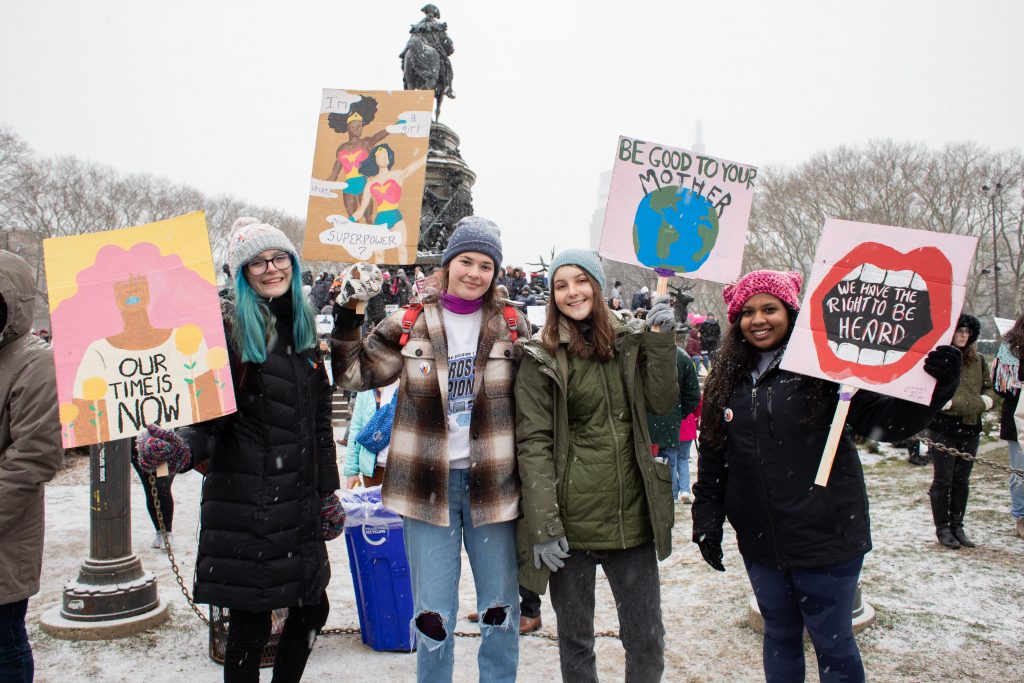 2020 01 18-b haydu-philadelphia pennsylvania ben franklin parkway logan circle museum of art-womens march-18 Downingtown East High School students Chloe Baumann, Hope Hessler, Megan Beale, and Gabbi Chacko traveled to Philadelphia to attend the Women's March. (Becca Haydu for WHYY)
