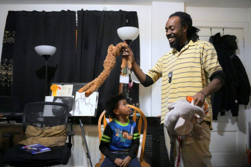 2020-01-21_009__BS20185-B-Slabbers-Deshaun-Sherrill-Zay’ion-Ventura-Sherrill-Philadelphia-West-Philadelphia-—-20200121__20200121-Single-Dad-Childcare-BS1694_2020_Bastiaan_Slabbers_for_WHYY_-e1580153452398 Single parent Deshaun Sherrill and his son Zay’ion Ventura-Sherrill clean up the living room of their home in West Philadelphia. (Bastiaan Slabbers for WHYY)