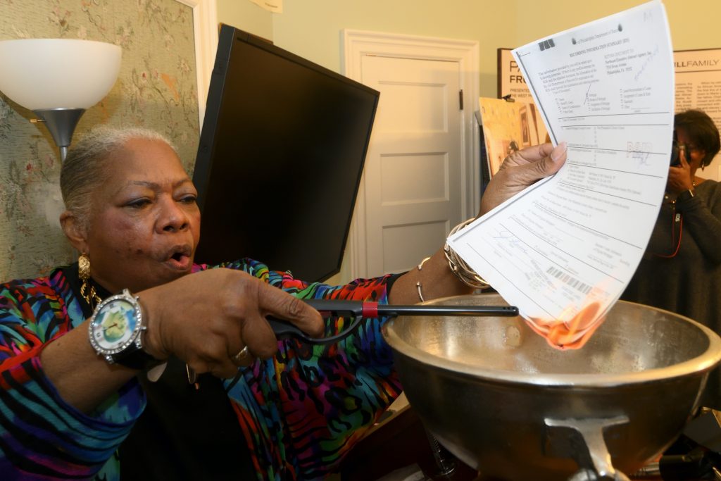 Ceremonial Mortgage Burning at Paul Robeson House Paul Robeson House Executive Director Vernoca Micheal lights the house's mortgage during a ceremonial burning on Saturday, Jan. 25, 2020. (Bastiaan Slabbers for WHYY)
