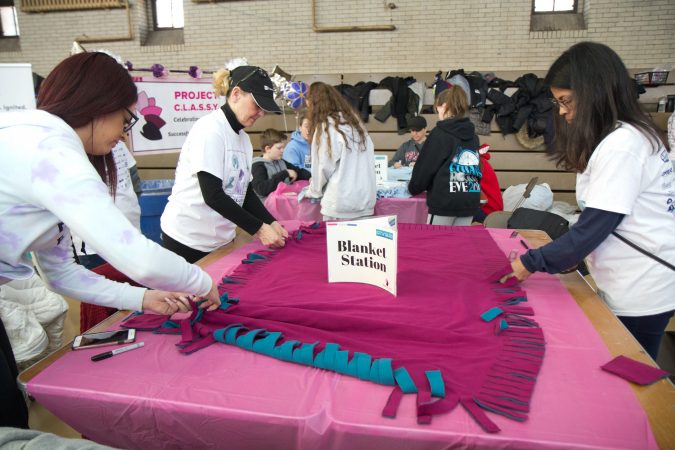 Volunteers make blankets at the Project C.L.A.S.S.Y. at the MLK Day of Service at Philadelphia’s Girard College. (Kimberly Paynter/WHYY)
