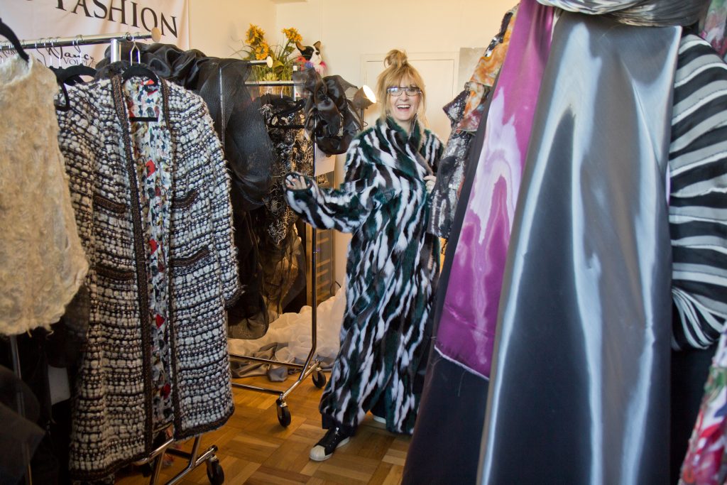 2020 1 29 k paynter nancy volpe-beringer-5 Nancy Volpe-Beringer wraps herself in an Eagles' inspired faux fur coat in her studio. (Kimberly Paynter/WHYY)
