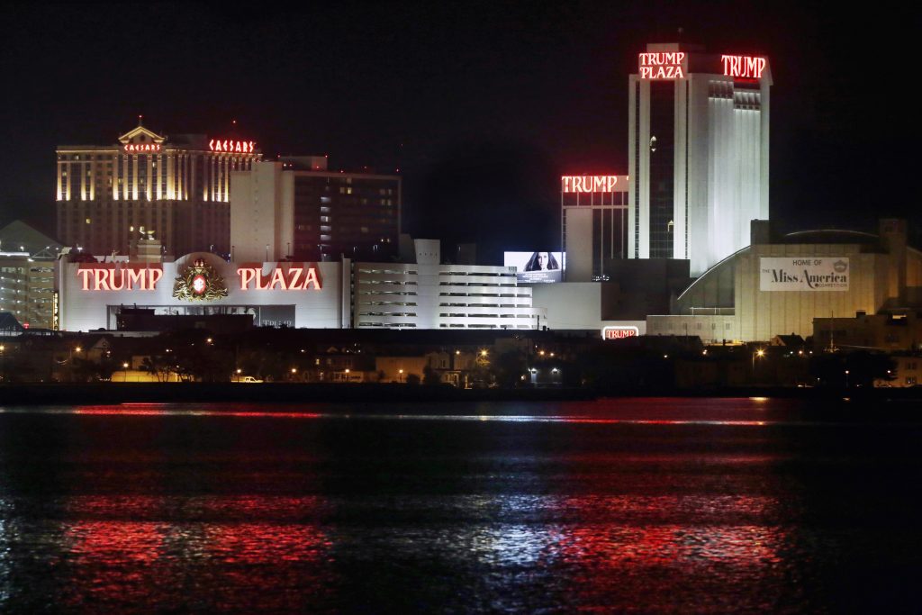 The Trump Plaza Hotel Casino is illuminated at night, just two weeks before closing on Sept. 16, 2014, in Atlantic City, N.J. (AP Photo/Mel Evans,file)