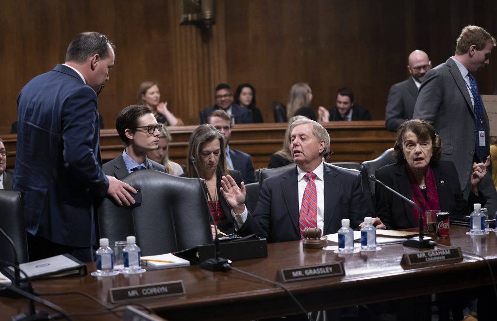 Lindsey Graham,Mike Lee Senate Judiciary Committee Chairman Lindsey Graham, R-S.C., right, speaks with Sen. Mike Lee, R-Utah, a member of the panel, who criticized a security briefing on Iran Wednesday by Secretary of State Mike Pompeo and other top officials, saying it was