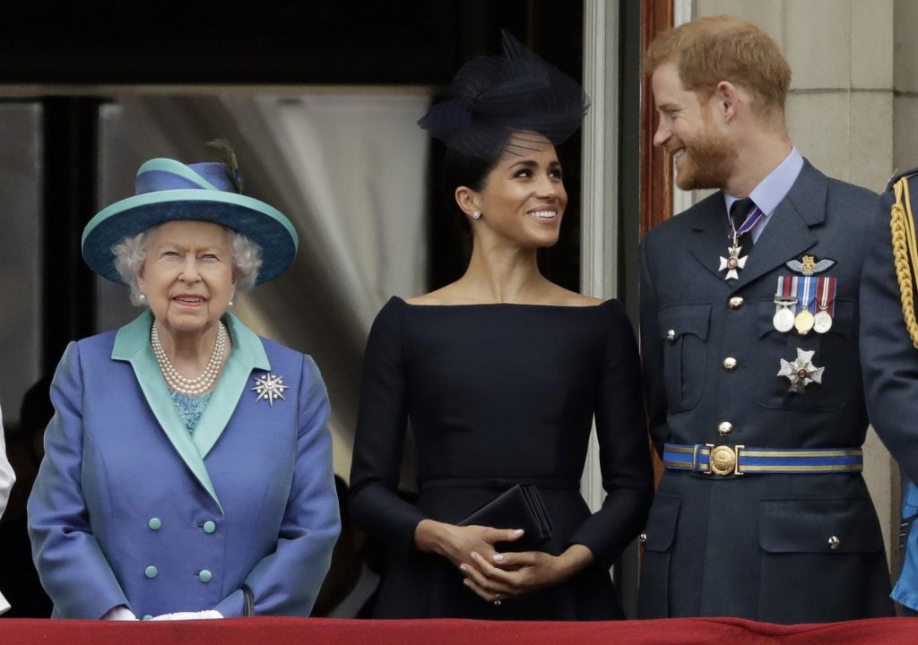 Britain Royal Rift In this Tuesday, July 10, 2018 file photo Britain's Queen Elizabeth II, and Meghan the Duchess of Sussex and Prince Harry watch a flypast of Royal Air Force aircraft pass over Buckingham Palace in London. (Matt Dunham/AP Photo)