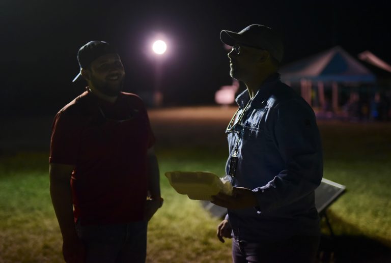 Men who lost their homes in a 6.4 magnitude earthquake stand inside a baseball stadium that has been opened to residents amid aftershocks and power outages, in Guayanilla, Puerto Rico.   (Carlos Giusti/AP Photo)