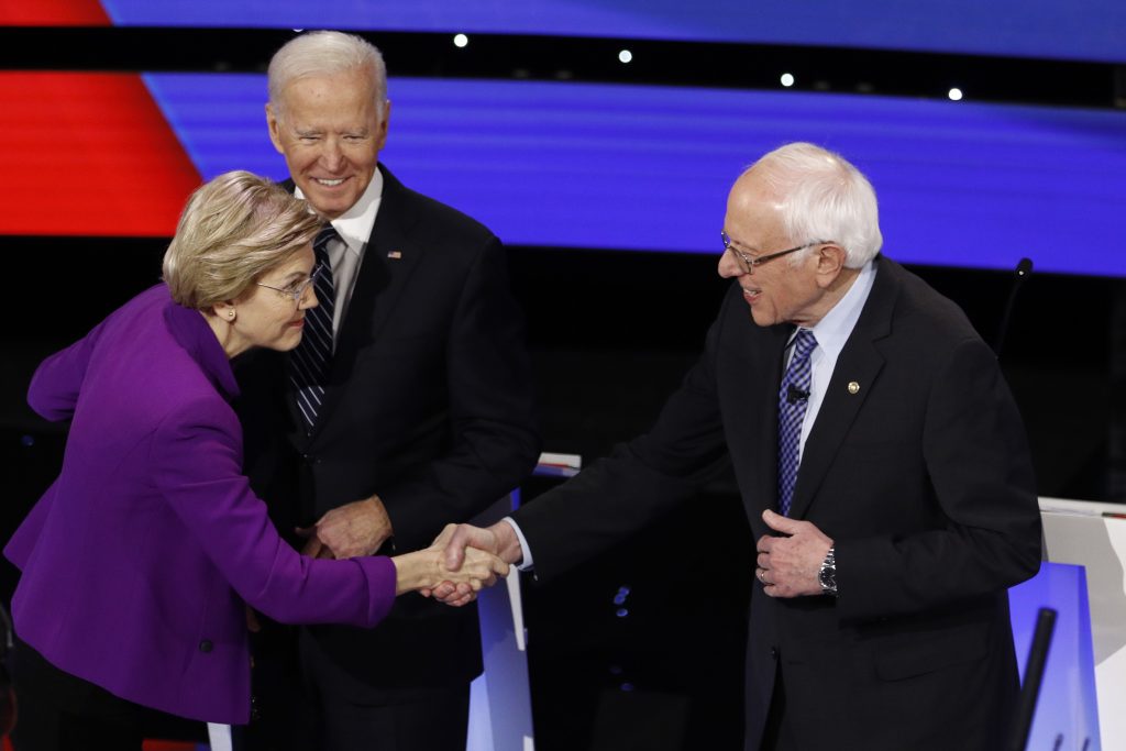 Election 2020 Debate Democratic presidential candidates Sen. Elizabeth Warren, D-Mass., left, and Sen. Bernie Sanders, I-Vt., right greet each other as former Vice President Joe Biden, watches Tuesday, Jan. 14, 2020, before a Democratic presidential primary debate hosted by CNN and the Des Moines Register in Des Moines, Iowa. (AP Photo/Patrick Semansky)