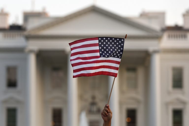 A supporter of the Deferred Action for Childhood Arrivals, or DACA, waves a flag during a rally outside the White House, in Washington, Monday, Sept. 4, 2017.  (AP Photo/Carolyn Kaster)