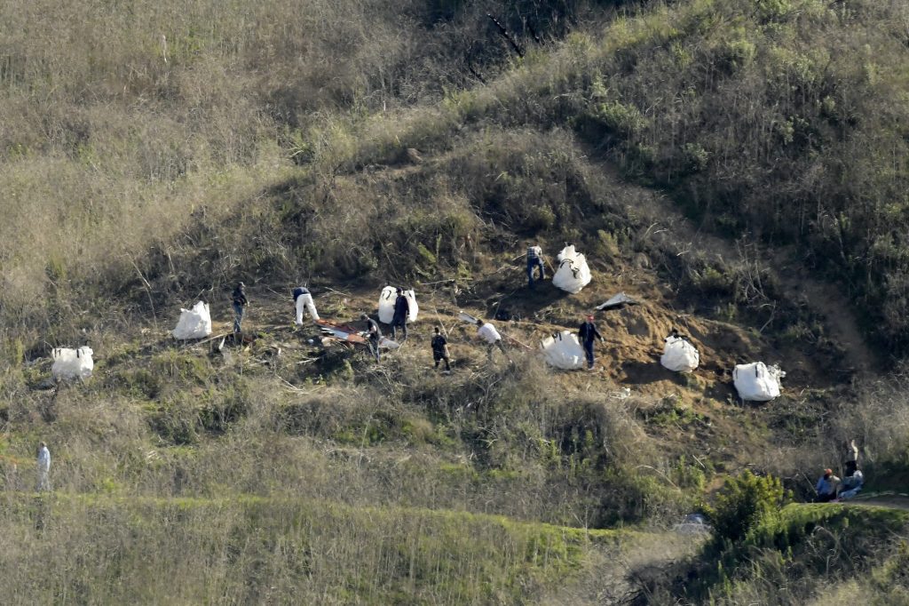 Helicopter Crash Kobe Bryant Killed Investigators work the scene of a helicopter crash that killed former NBA basketball player Kobe Bryant, his 13-year-old daughter, Gianna, and seven others Monday, July 23, 2018, in Calabasas, Calif. (Mark J. Terrill/AP Photo)