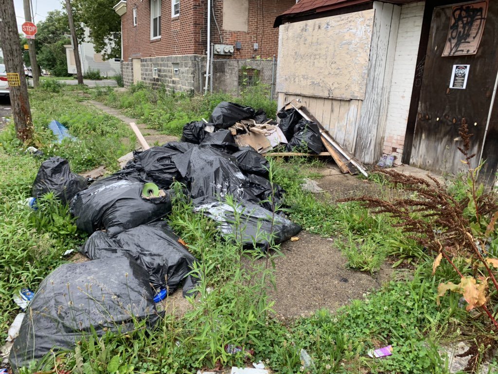 D9bHozAX4AE8KWR Bagged construction material dumped in front of a