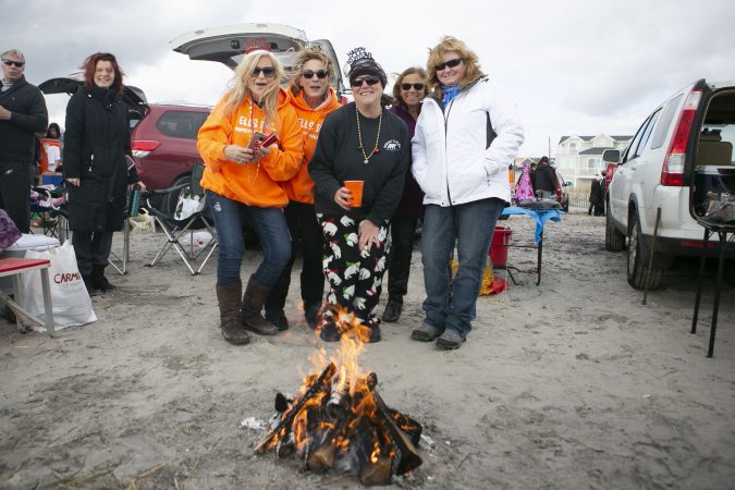 Participants of the 2020 polar bear plunge in Margate, NJ pose for a picture during on Wednesday, January 1, 2020. (Miguel Martinez for WHYY)