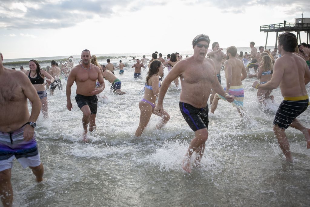 Hounds walk to help save others of their kind Participants of the 2020 polar bear plunge in Margate, NJ run to the ocean on Wednesday, January 1, 2020. (Miguel Martinez for WHYY)