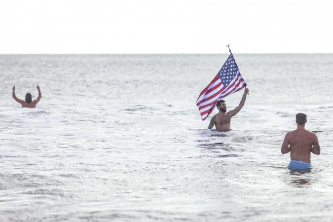 Teddy Costa jump in the ocean during the 2020 polar bear plunge in Margate, NJ on Wednesday, January 1, 2020. (Miguel Martinez for WHYY)