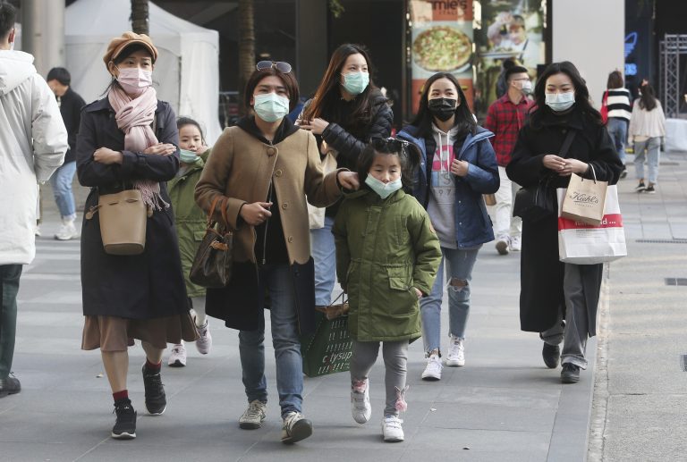 People wear face masks as they visit a shopping district in Taipei, Taiwan, Friday, Jan. 31, 2020. People wear face masks as they walk through a shopping mall in Taipei, Taiwan, Friday, Jan. 31, 2020. (AP Photo/Chiang Ying-ying)