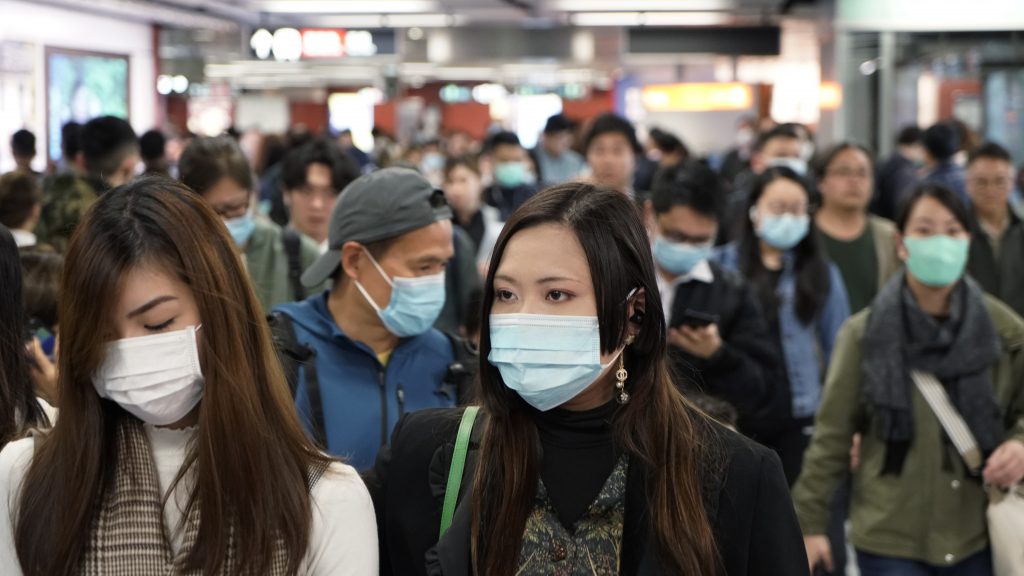 Passengers in a subway station in Hong Kong on Wednesday wear masks amid the coronavirus outbreak. Passengers in a subway station in Hong Kong wear masks amid the coronavirus outbreak. (Kin Cheung/AP Photo)