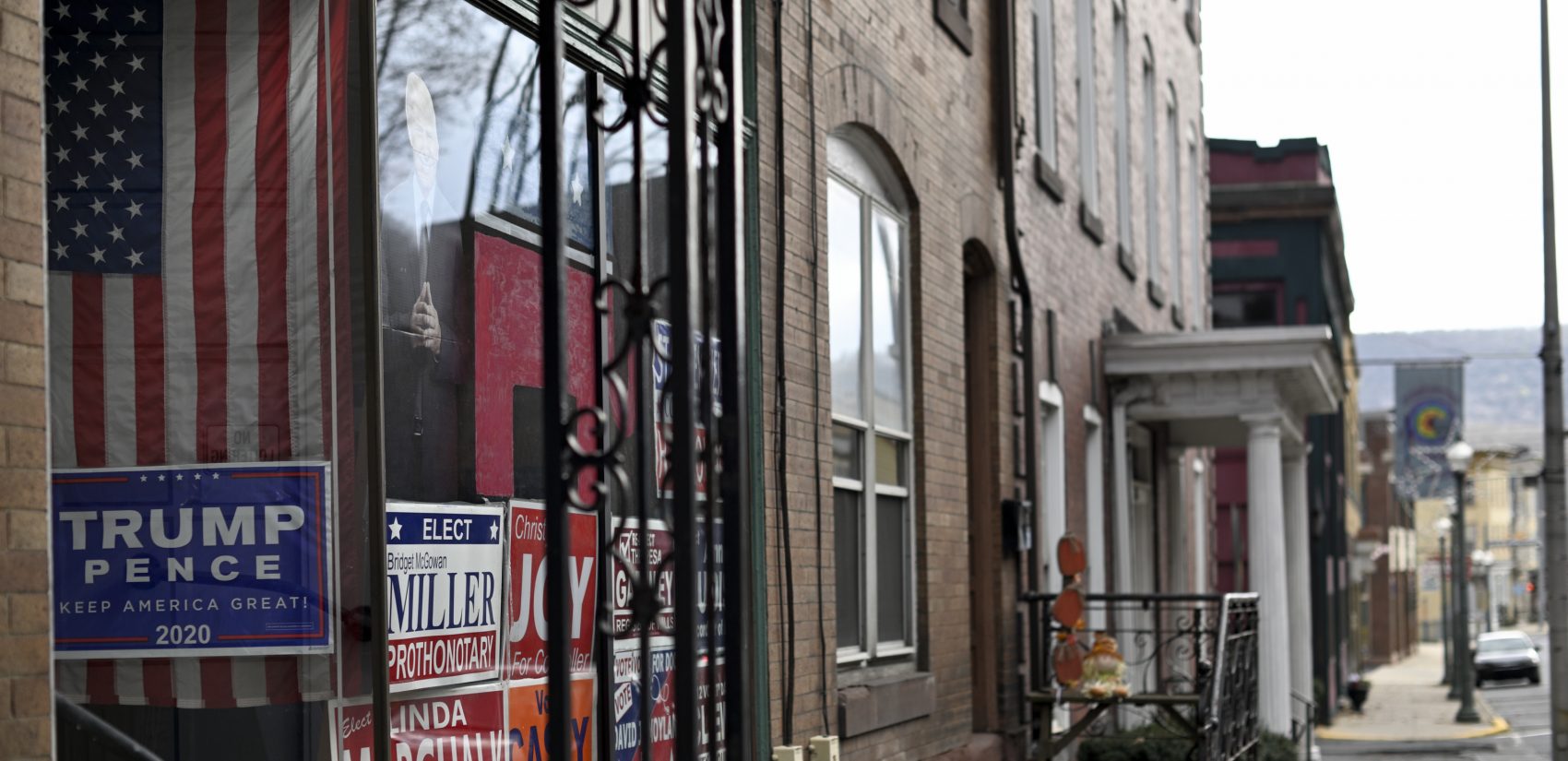 Campaign signs in support of Republican candidates and a cardboard cut-out portrait of President Donald Trump decorate a window along Hotel St. in Pottsville, Pa. (Bas Slabbers for Keystone Crossroads)