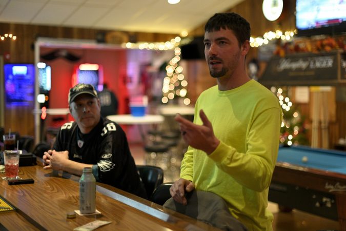 Assistant Fire Chief Cody Yeich, 32, at the Landingville Community Fire Company in Schuylkill County with bar steward Steve Schaeffer. (Bas Slabbers for Keystone Crossroads)