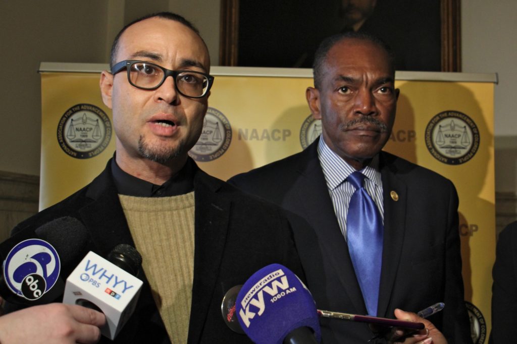 2020 02 27-e lee-robert holbrook rodney muhammad-philadelphia city hall-prison gerrymandering lawsuit The NAACP has filed suit on behalf of Robert Holbrook (left) and other currently and formerly incarcerated people whose Census numbers apply to the community where they are incarcerated rather than where they live. Holbrook spoke during a press conference at City Hall, accompanied by Philadelphia NAACP President Rodney Muhammad (right). (Emma Lee/WHYY)