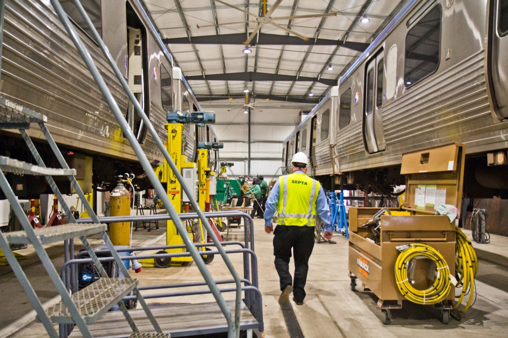 2020 1 30 k paynter septa el car fix-4 Two Market-Frankford Line cars lifted for repairs at the 69th Street SEPTA repair shop. (Kimberly Paynter/WHYY)
