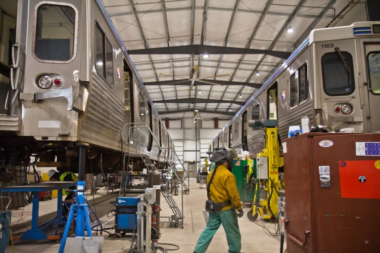 Two Market-Frankford Line cars lifted for repairs at the 69th Street SEPTA repair shop. (Kimberly Paynter/WHYY)