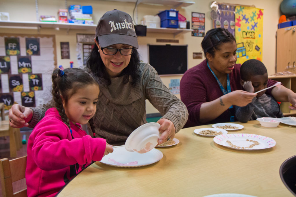 2020 2 19 k paynter SPIN autism support-6 Kids in SPIN’s autism support preschool classroom work on their motor skills by creating a marshmallow fluff and Cheerio heart craft project. (Kimberly Paynter/WHYY)