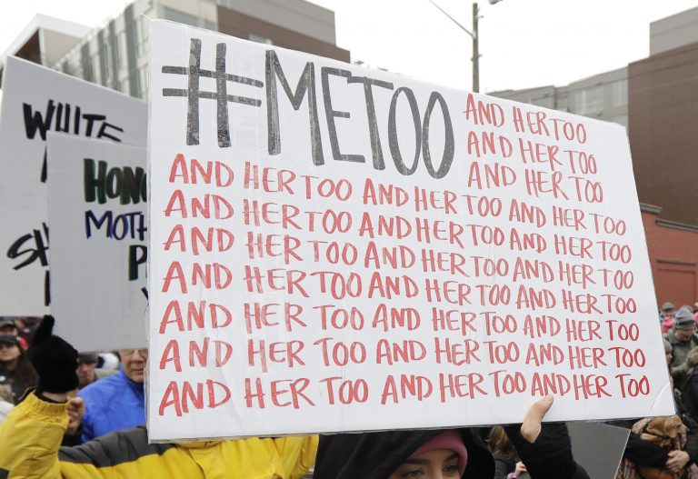In this Jan. 20, 2018 file photo, a marcher carries a sign with the popular Twitter hashtag #MeToo used by people speaking out against sexual harassment as she takes part in a Women's March in Seattle. (AP Photo/Ted S. Warren, File)