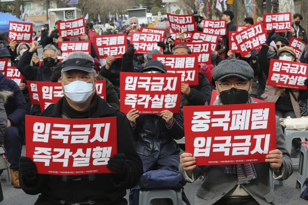 China Outbreak Xenophobic Sentiment In this Wednesday, Jan. 29, 2020, photo, South Korean protesters stage a rally calling for a ban on Chinese people entering South Korea near the presidential Blue House in Seoul, South Korea. (Ahn Young-joon/AP Photo)