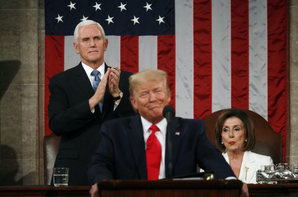APTOPIX State of the Union U.S. Vice President Mike Pence stands and applauds as Speaker of the House Nancy Pelosi reacts to President Donald Trump as he delivers his State of the Union address. (REUTERS/Leah Millis/POOL)