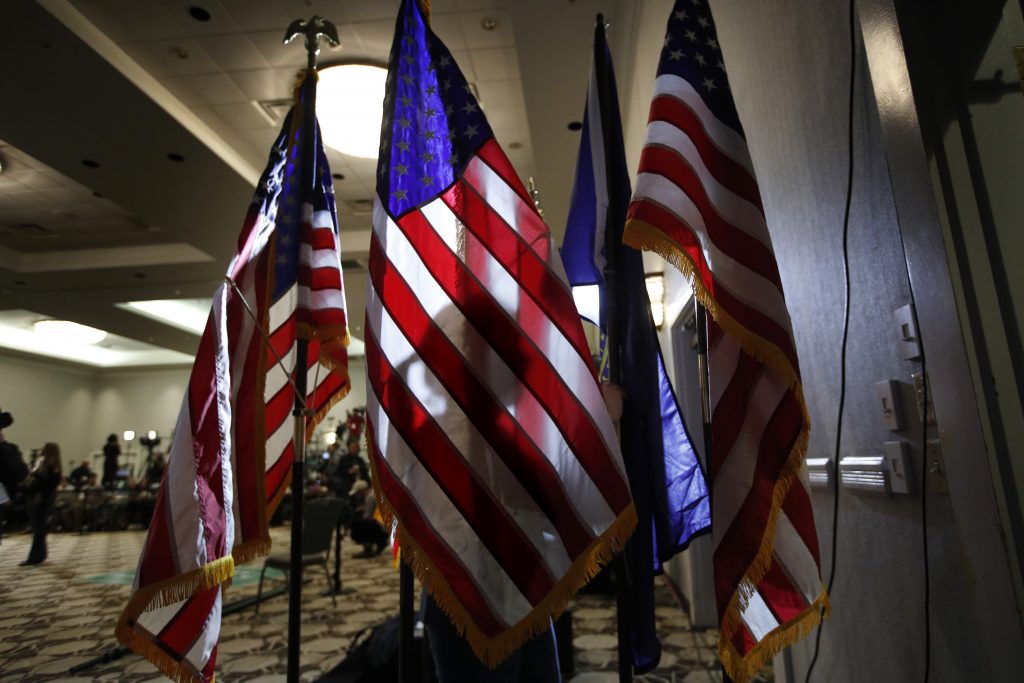Madisson Morris Campaign worker Madisson Morris, of St.Paul, Minn., sets up flags at the election night headquarters for Democratic presidential candidate Sen. Amy Klobuchar, D-Minn.,Tuesday, Feb. 11, 2020, in Concord, N.H. (AP Photo/Robert F. Bukaty)