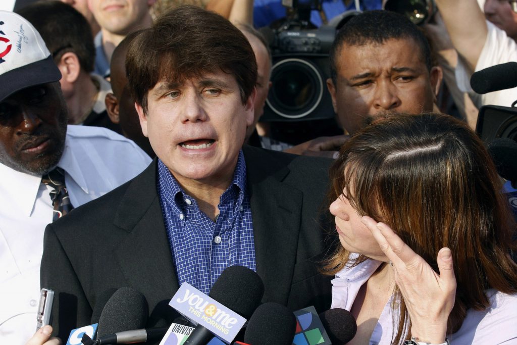 Rod Blagojevich, Patti Blagojevich FILE - In this March 14, 2012, file photo, former Illinois Gov. Rod Blagojevich speaks to the media outside his home in Chicago as his wife, Patti, wipes away tears a day before reporting to prison after his conviction on corruption charges. President Donald Trump is expected to commute the 14-year prison sentence of Blagojevich. The 63-year-old Democrat is expected to walk out of prison later Tuesday, Feb. 18, 2020. (AP Photo/M. Spencer Green, File)
