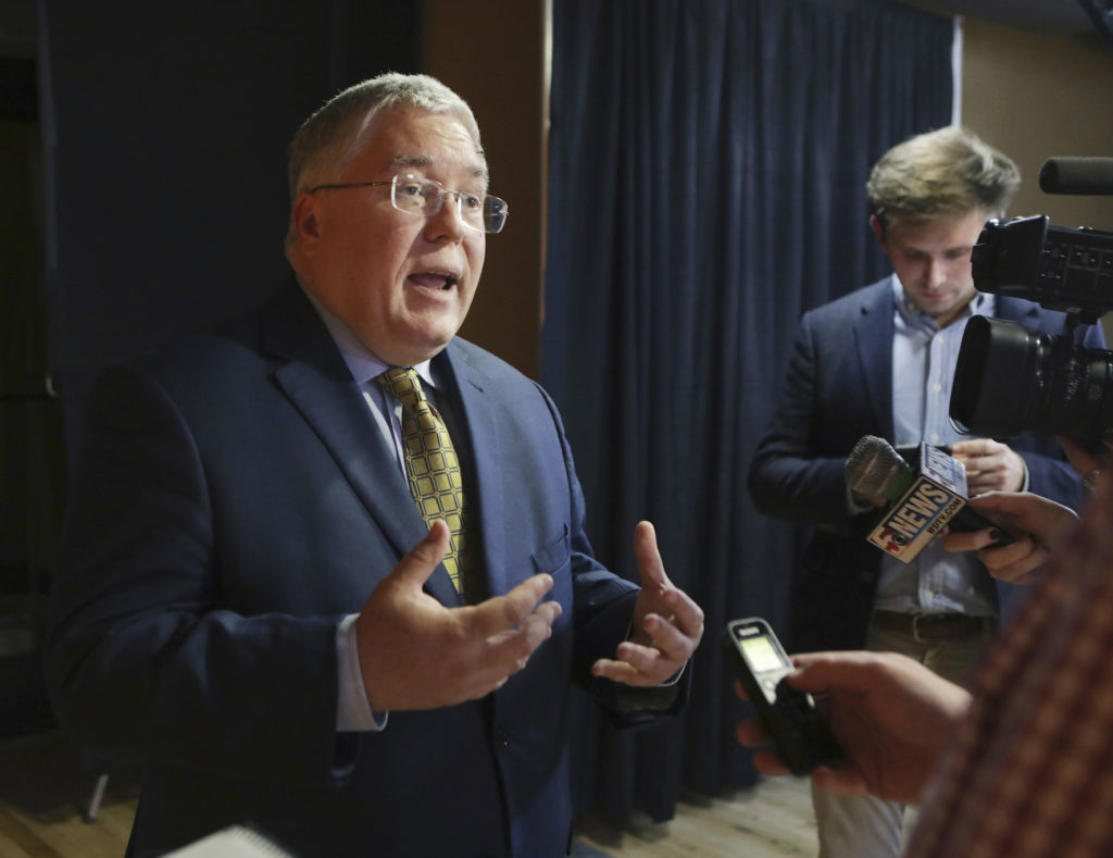 Patrick Morrisey speaks to reporters after a debate in Morgantown, W.Va. State attorneys general are finding a national settlement over the toll of opioids to be elusive, as some lawyers for state and local governments are renewing public criticism of the proposed deal with a group of companies led by the nation's largest drug distributors. (Raymond Thompson, File, AP Photo)