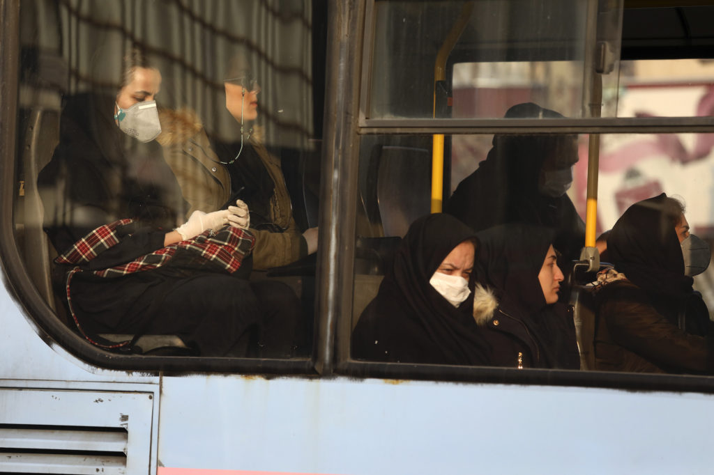 APTOPIX Virus Outbreak Mideast Iran Woman, wearing face masks, travel on a public bus in a street in western Tehran, Iran, Saturday, Feb. 29, 2020. (Vahid Salemi/AP Photo)