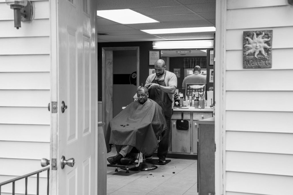 Chambersburg_243 Lance Walker with a customer at his barbershop in Chambersburg, Pa. (Jeffrey Stockbridge for Keystone Crossroads)