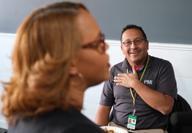 Cafe co-owner and Reading City Council Member Johanny Cepeda-Freytiz, left, speaks as Rudy Estrada, right, with the Reading Codes Department. (Matt Smith for Keystone Crossroads)