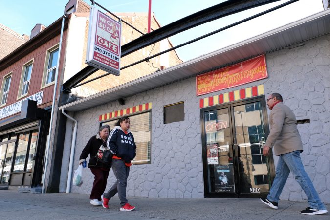 People walk past Mi Casa Su Casa cafe on Penn Street in Reading, Pennsylvania. (Matt Smith for Keystone Crossroads)
