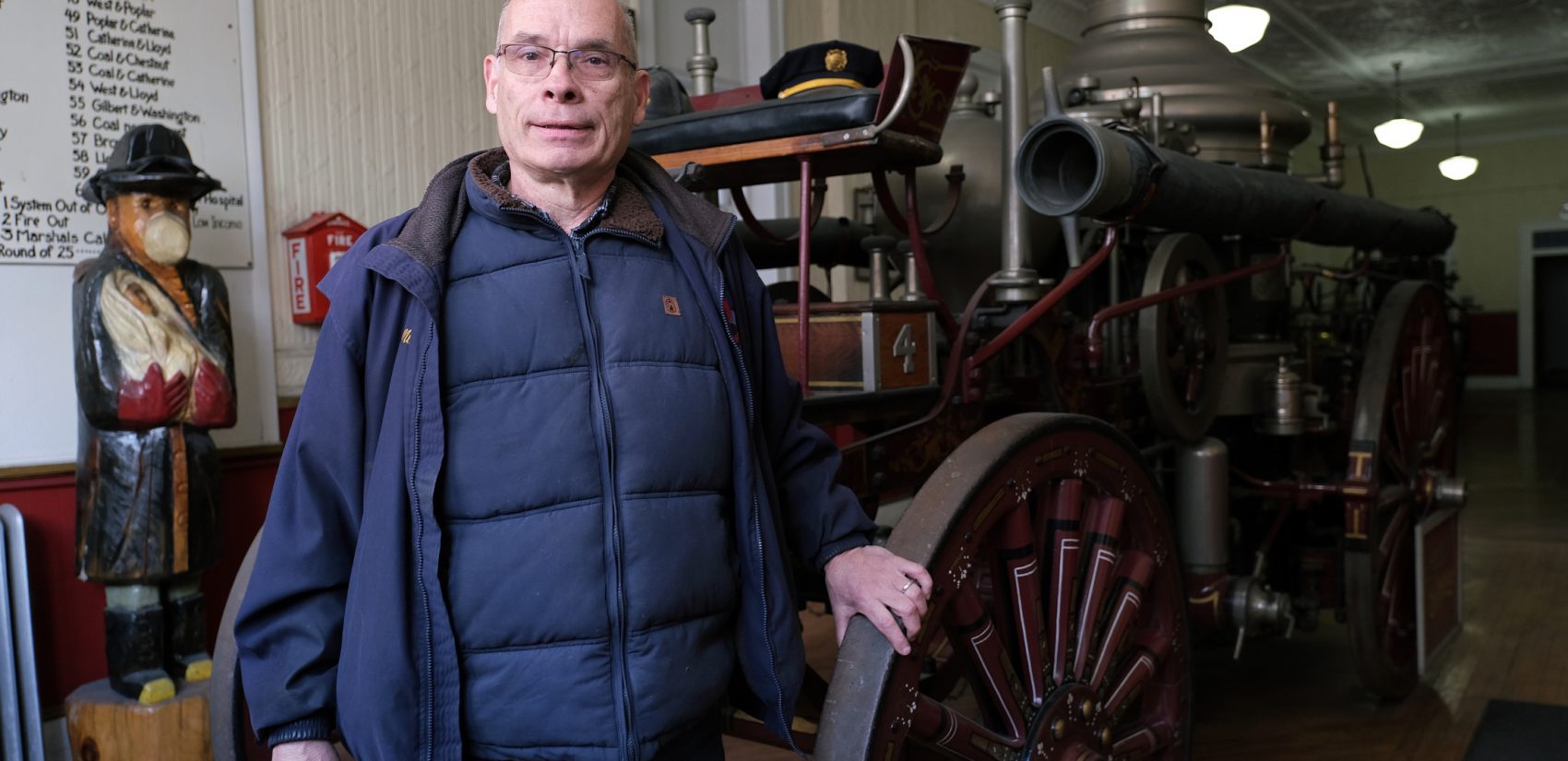 Veteran firefighter Mike Kitsock stands by a 1909 Ahrens Continental steam fire engine at the Schuylkill Historical Fire Society in Shenandoah, Pennsylvania. (Matt Smith for Keystone Crossroads)