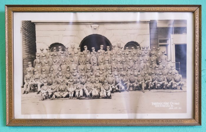 A photograph of a company firefighters taken in 1942 is displayed at Phoenix Fire Company No. 2 in Shenandoah, Pennsylvania. (Matt Smith for Keystone Crossroads)