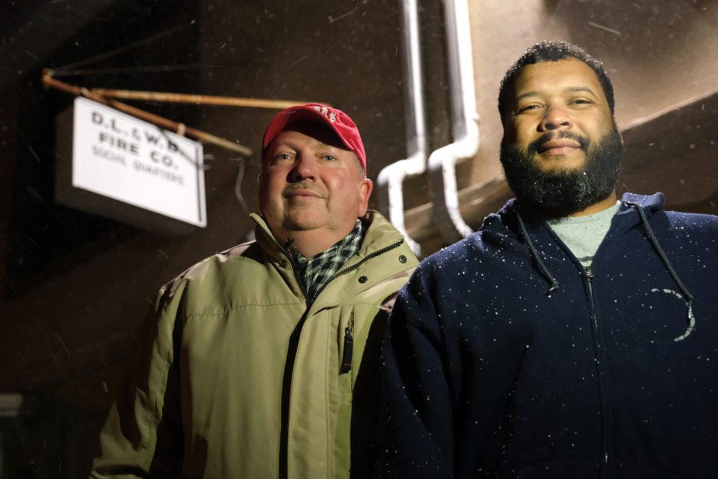 Schuylkill County Firehouses 78 Andrew Barrow, left, and his brother Ronald Stanley Webb, Jr, nicknamed Stosh, right, stand outside Deer Lake and West Brunswick Fire Co. on Jan. 16, 2020, in Deer Lake, Pennsylvania. Webb was subjected to a racial slur while at Port Clinton Fire Company and his brother Barrow wrote an op-ed in the newspaper to bring attention to it. (Matt Smith for Keystone Crossroads)
