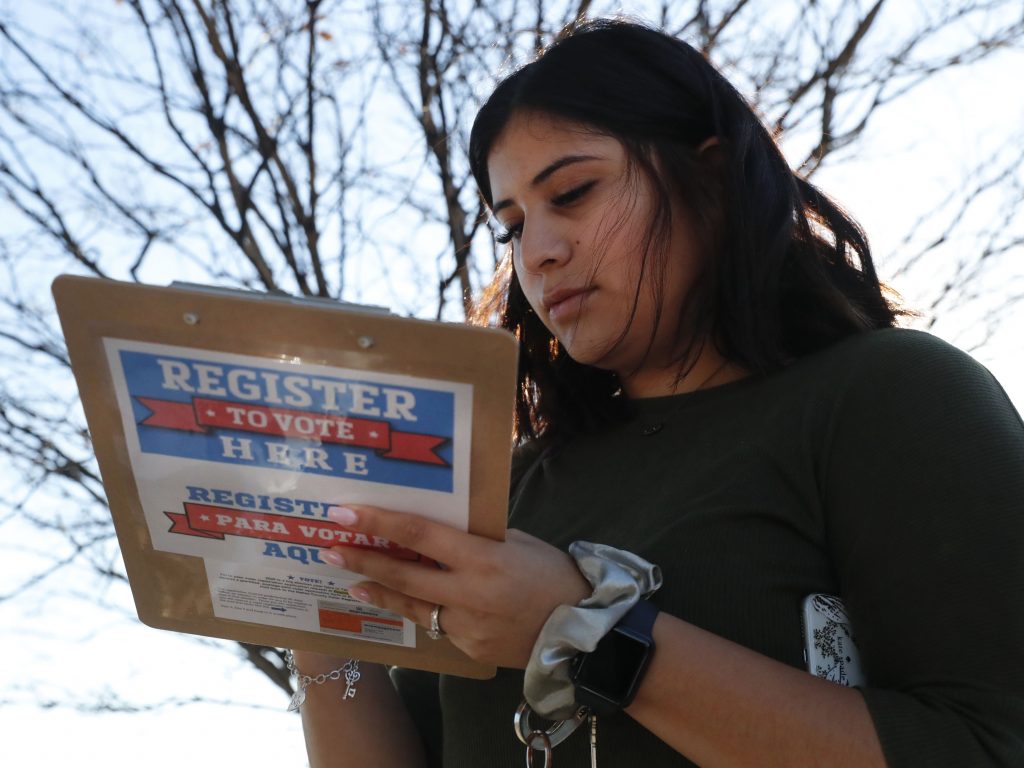 Karina Shumate, 21, a college student, filled out a voter registration form in Richardson, Texas on Jan. 18. One big registration effort this year has drawn controversy among elections officials. Karina Shumate, 21, a college student, filled out a voter registration form in Richardson, Texas on Jan. 18. One big registration effort this year has drawn controversy among elections officials. (LM Otero/AP)