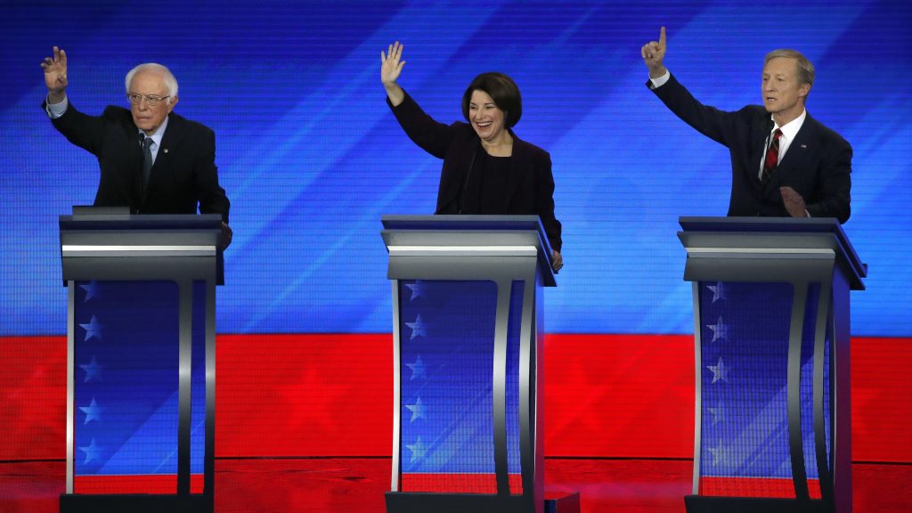 Democratic presidential candidates, Sen. Bernie Sanders (left), Sen. Amy Klobuchar and businessman Tom Steyer raise their hands during a Democratic presidential primary debate on Friday at Saint Anselm College in Manchester, N.H. Democratic presidential candidates, Sen. Bernie Sanders (left), Sen. Amy Klobuchar and businessman Tom Steyer raise their hands during a Democratic presidential primary debate on Friday at Saint Anselm College in Manchester, N.H. (Elise Amendola/AP Photo)