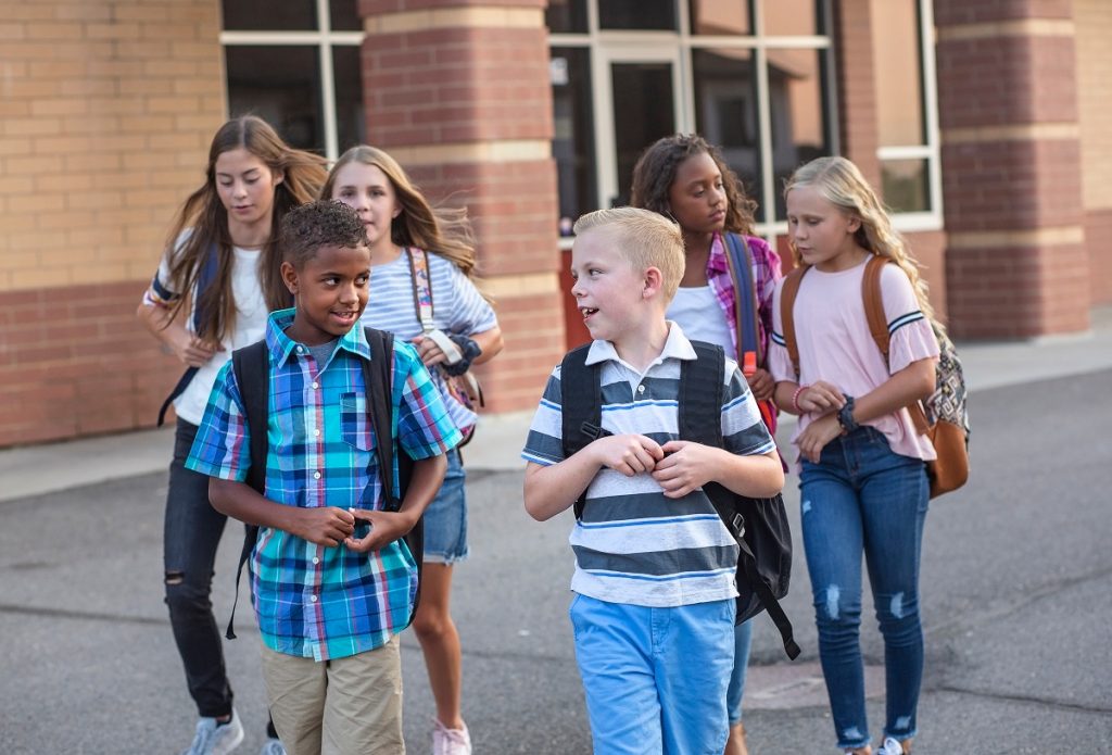 Large, diverse group of kids leaving school at the end of the da (Big Stocks)