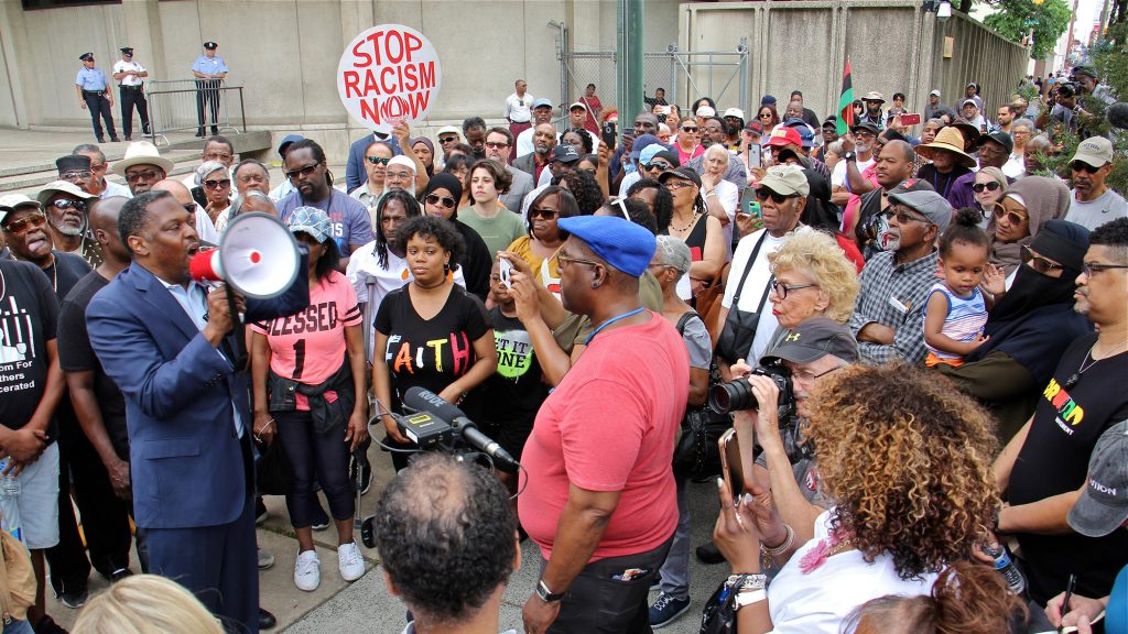 Protesters gather at Philadelphia police headquarters to call for action against police officers who posted racist comments on Facebook. (Emma Lee/WHYY)