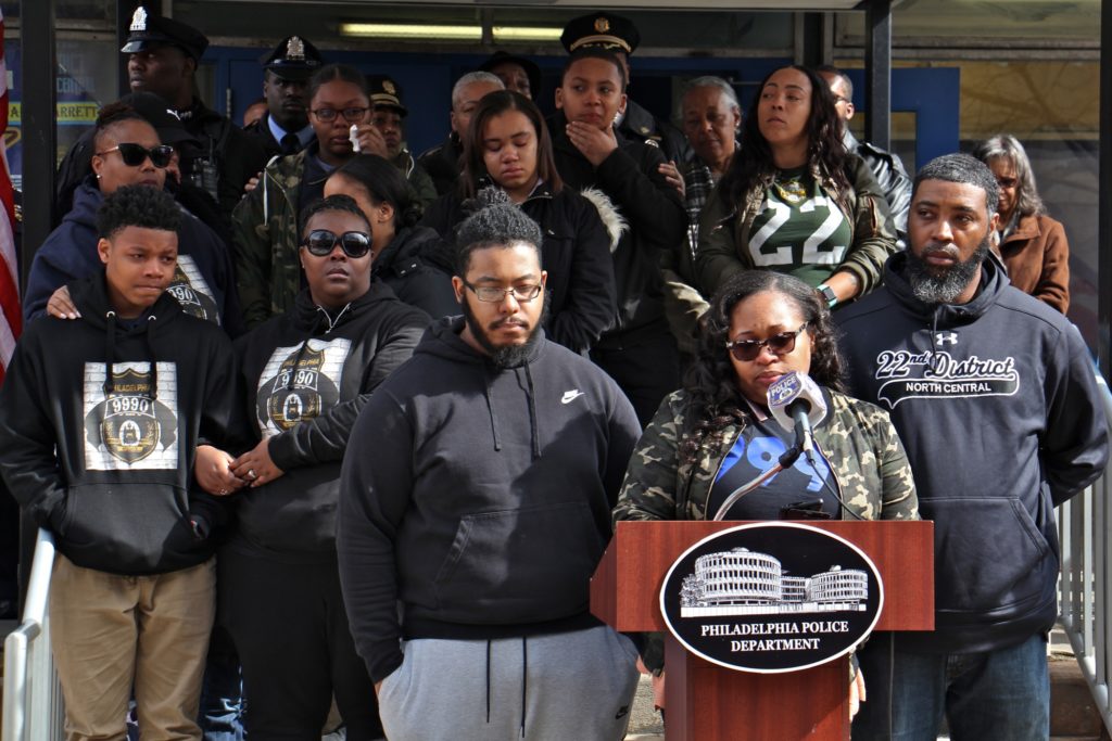 2020 03 05-e lee-shakira wilson burroughs-philadelphia 22nd police district-robert wilson memorial Shaki'ra Wilson Burroughs, backed by her extended family, speaks about the loss of her brother, Philadelphia Police Officer Robert Wilson, during a memorial ceremony on the fifth anniversary of his death. Wilson was shot to death by armed robbers at a video game store. (Emma Lee/WHYY)