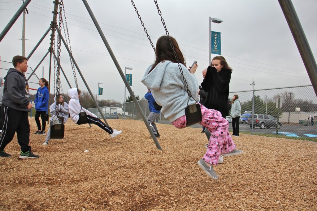 2020 03 06-e lee-warrington titus elementary school-virus shuts down schools Children gather on the playground at Titus Elementary School, playing and talking to news reporters about the threat of the virus that shut down their school and four others in Central Bucks County. (Emma Lee/WHYY)