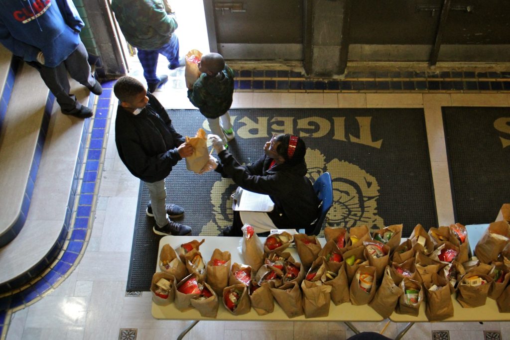 2020 03 16-e lee-philadelphia tilden school-school meals during pandemic Daaiyah Boone hands out bagged meals to students at Tilden Middle School during the coronavirus shutdown. (Emma Lee/WHYY)